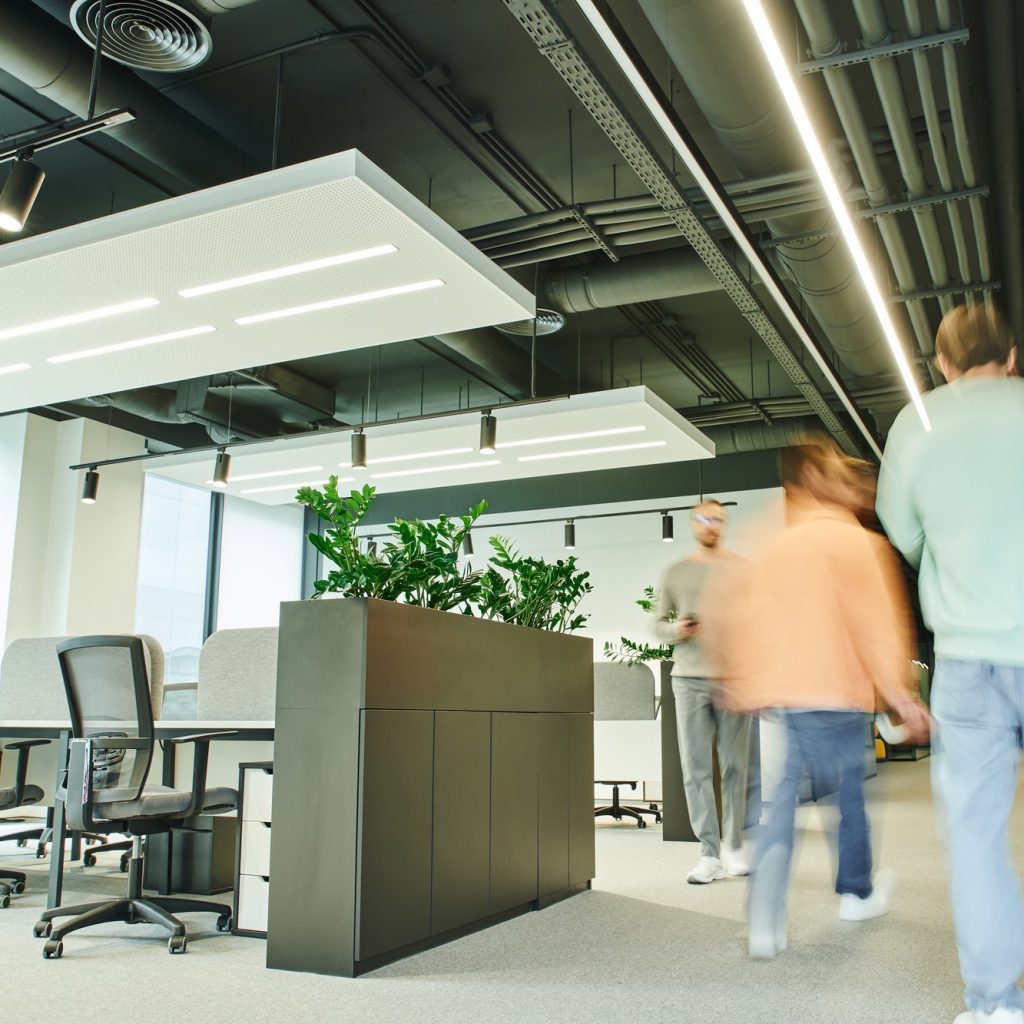 motion blur of businessmen walking in contemporary and spacious coworking office with modern